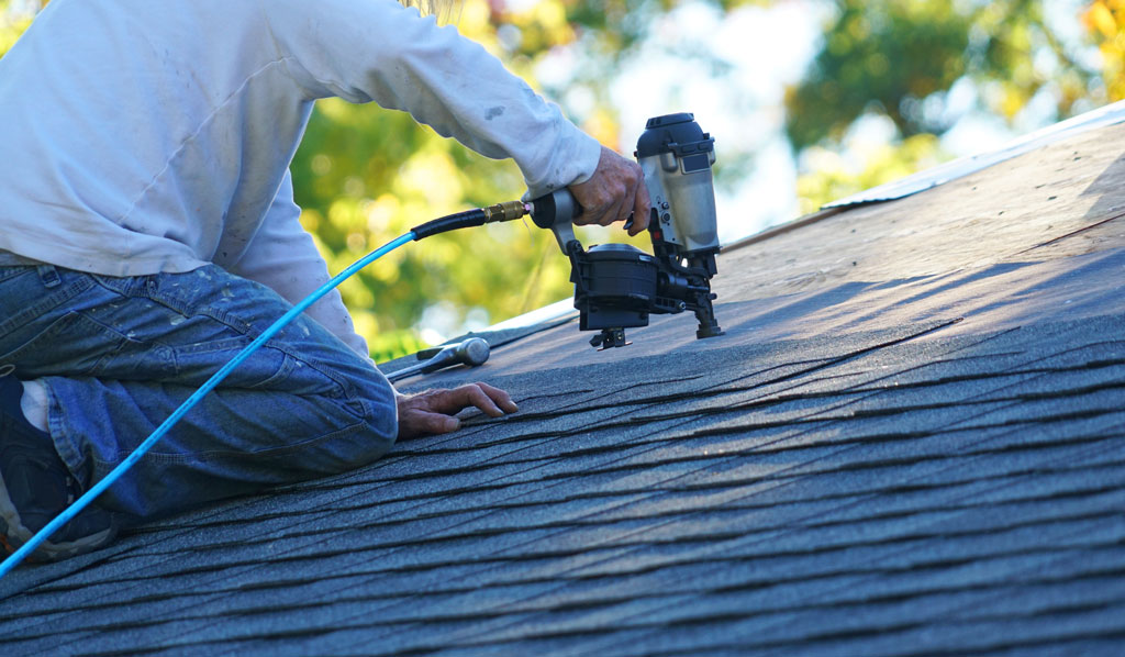 a person using a tool to install a roof a person using a tool to install a roof