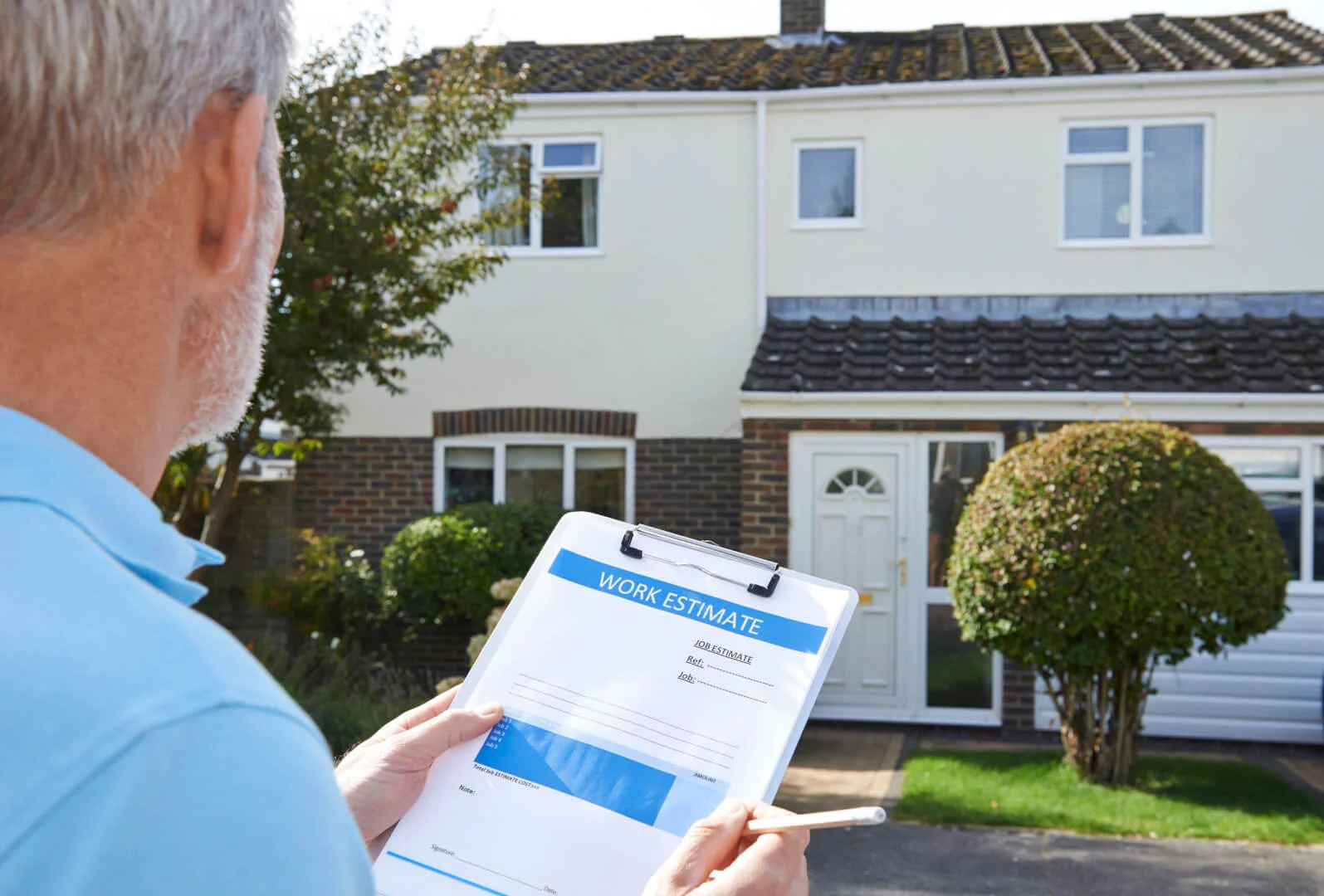 a man holding a clipboard in front of a house with a roof a man holding a clipboard in front of a house with a roof
